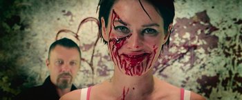 Movie still from “Dredd” (2012), directed by Pete Travis – A woman with blood dripping from her face; Close Up shot, Low angle