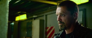 Movie still from “Dredd” (2012), directed by Pete Travis – A person wearing a jacket; Close Up shot, Low angle