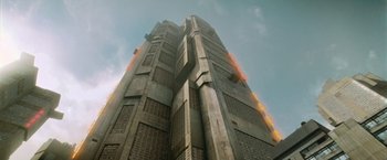 Movie still from “Dredd” (2012), directed by Pete Travis – Looking up at a very tall building in the sky; Extreme Wide shot, Low angle