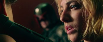 Movie still from “Dredd” (2012), directed by Pete Travis – A woman and a man are looking at the camera; Close Up shot, Low angle