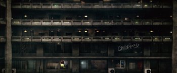 Movie still from “Dredd” (2012), directed by Pete Travis – An image of a building that has many windows in it; Extreme Wide shot, Overhead angle