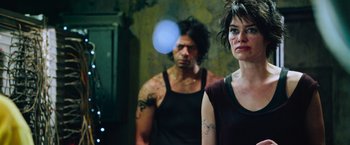 Movie still from “Dredd” (2012), directed by Pete Travis – A man and a woman standing next to each other; Medium shot, Over the shoulder angle