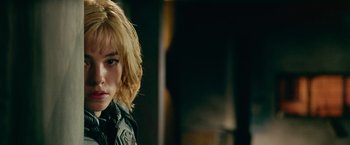 Movie still from “Dredd” (2012), directed by Pete Travis – A person wearing a jacket; Close Up shot, Over the shoulder angle