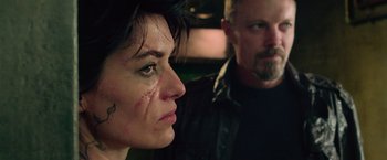 Movie still from “Dredd” (2012), directed by Pete Travis – A man and a woman are looking at each other; Close Up shot, Over the shoulder angle