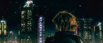 Movie still from “Dredd” (2012), directed by Pete Travis – A person looking out over a city at night; Medium shot, Over the shoulder angle
