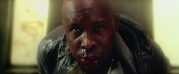 Movie still from “Dredd” (2012), directed by Pete Travis – A person with blood on his face; Extreme Close Up shot, Overhead angle