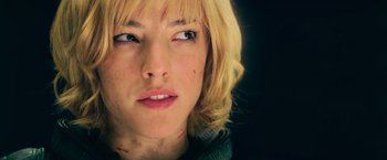 Movie still from “Dredd” (2012), directed by Pete Travis – A woman's face with red spots on it; Close Up shot, Low angle