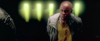 Movie still from “Dredd” (2012), directed by Pete Travis – A bald man with blood all over his face; Close Up shot, High angle