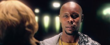 Movie still from “Dredd” (2012), directed by Pete Travis – A man with a beard is looking at the camera; Close Up shot, Low angle