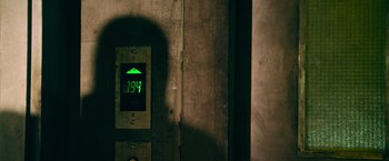 Movie still from “Dredd” (2012), directed by Pete Travis – A green light is on in a building; Extreme Close Up shot, Overhead angle