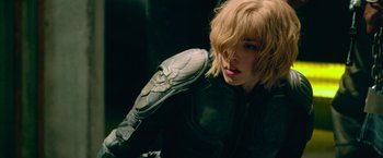 Movie still from “Dredd” (2012), directed by Pete Travis – A person wearing a motorcycle jacket; Close Up shot, Over the shoulder angle