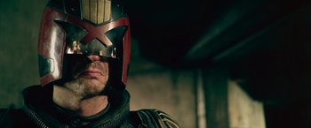 Movie still from “Dredd” (2012), directed by Pete Travis – A person wearing a helmet; Close Up shot, Low angle