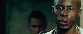 Movie still from “Dredd” (2012), directed by Pete Travis – A man with a goatee is looking into the distance; Close Up shot, Low angle