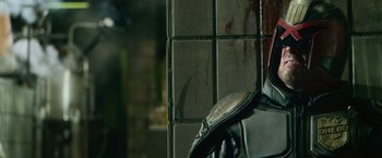 Movie still from “Dredd” (2012), directed by Pete Travis – A person wearing a leather jacket; Close Up shot, Over the shoulder angle