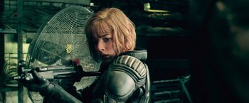 Movie still from “Dredd” (2012), directed by Pete Travis – A woman with blonde hair wearing a helmet; Close Up shot, Over the shoulder angle