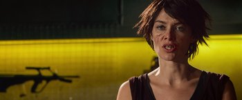 Movie still from “Dredd” (2012), directed by Pete Travis – A person wearing a black shirt; Close Up shot, Low angle