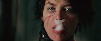 Movie still from “Dredd” (2012), directed by Pete Travis – A person blowing a bubble with gum; Close Up shot, Low angle