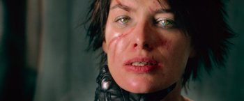 Movie still from “Dredd” (2012), directed by Pete Travis – A woman's face covered in blood; Close Up shot, Low angle