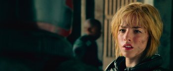 Movie still from “Dredd” (2012), directed by Pete Travis – A person with blond hair; Close Up shot, Over the shoulder angle