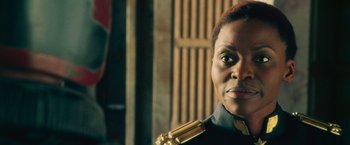 Movie still from “Dredd” (2012), directed by Pete Travis – A person wearing a uniform; Close Up shot, Low angle