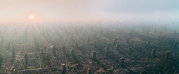 Movie still from “Dredd” (2012), directed by Pete Travis – An aerial view of a large city in the middle of the day; Extreme Wide shot, High angle