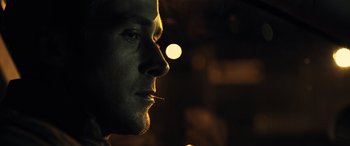 Movie still from “Drive” (2011), directed by Nicolas Winding Refn – A person smoking a cigarette; Close Up shot, Over the shoulder angle