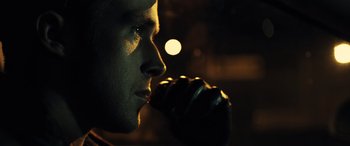 Movie still from “Drive” (2011), directed by Nicolas Winding Refn – A person drinking from a cup; Close Up shot, Over the shoulder angle