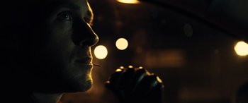 Movie still from “Drive” (2011), directed by Nicolas Winding Refn – A man's face in the dark; Close Up shot, Low angle