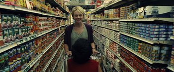 Movie still from “Drive” (2011), directed by Nicolas Winding Refn – A woman pushing a shopping cart in a grocery store; Medium shot, Over the shoulder angle