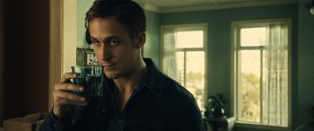 Movie still from “Drive” (2011), directed by Nicolas Winding Refn – A person in a room near a window; Close Up shot, Over the shoulder angle