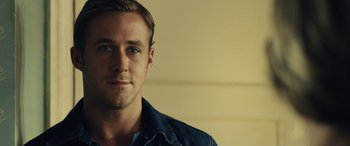 Movie still from “Drive” (2011), directed by Nicolas Winding Refn – A person wearing a jean jacket; Close Up shot, Over the shoulder angle