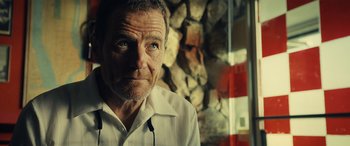 Movie still from “Drive” (2011), directed by Nicolas Winding Refn – An older man wearing a white dress shirt; Close Up shot, Over the shoulder angle