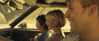 Movie still from “Drive” (2011), directed by Nicolas Winding Refn – A group of people in the back seat of a car; Close Up shot, Over the shoulder angle