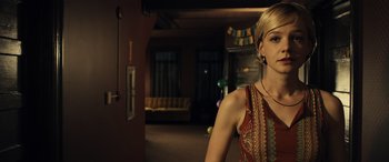 Movie still from “Drive” (2011), directed by Nicolas Winding Refn – A woman standing in a living room wearing a red dress; Medium shot, Low angle