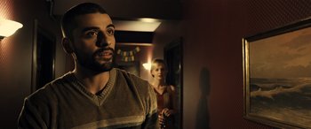 Movie still from “Drive” (2011), directed by Nicolas Winding Refn – A man and a woman standing in a room; Close Up shot, Over the shoulder angle