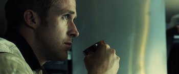 Movie still from “Drive” (2011), directed by Nicolas Winding Refn – A person holding a cell phone; Close Up shot, Over the shoulder angle