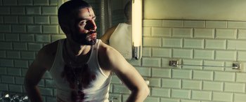 Movie still from “Drive” (2011), directed by Nicolas Winding Refn – A man in a white shirt with a bloody face; Medium shot, Low angle