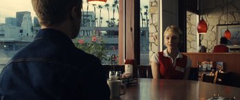 Movie still from “Drive” (2011), directed by Nicolas Winding Refn – A man and a woman sitting at a table in front of a window; Medium shot, Over the shoulder angle