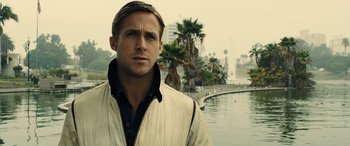 Movie still from “Drive” (2011), directed by Nicolas Winding Refn – A person near a body of water; Close Up shot, Over the shoulder angle