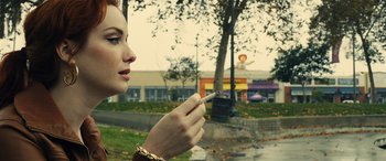 Movie still from “Drive” (2011), directed by Nicolas Winding Refn – A woman is holding a cigarette in her hand; Close Up shot, Low angle