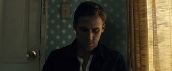 Movie still from “Drive” (2011), directed by Nicolas Winding Refn – A person wearing a black jacket; Close Up shot, Low angle