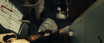 Movie still from “Drive” (2011), directed by Nicolas Winding Refn – A man with blood all over his face and body; Medium shot, Overhead angle