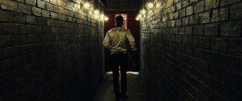Movie still from “Drive” (2011), directed by Nicolas Winding Refn – A man walking down a dark alley way; Wide shot, Low angle