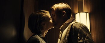 Movie still from “Drive” (2011), directed by Nicolas Winding Refn – A man and a woman kissing each other in the dark; Close Up shot, Low angle