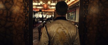 Movie still from “Drive” (2011), directed by Nicolas Winding Refn – A man wearing a jacket in a restaurant; Medium shot, Over the shoulder angle