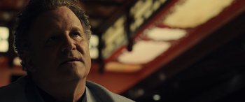 Movie still from “Drive” (2011), directed by Nicolas Winding Refn – A person wearing a suit and tie; Close Up shot, Low angle