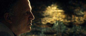 Movie still from “Drive” (2011), directed by Nicolas Winding Refn – A man's face in front of an artistic background; Close Up shot, Low angle