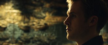 Movie still from “Drive” (2011), directed by Nicolas Winding Refn – A man's face in front of a blurry background; Close Up shot, Low angle