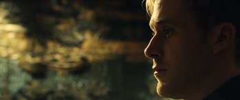 Movie still from “Drive” (2011), directed by Nicolas Winding Refn – A man's face in the sunlight; Close Up shot, Low angle