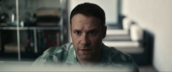 Movie still from “Dumb Money” (2023), directed by Craig Gillespie – A person wearing a green shirt; Close Up shot, Over the shoulder angle